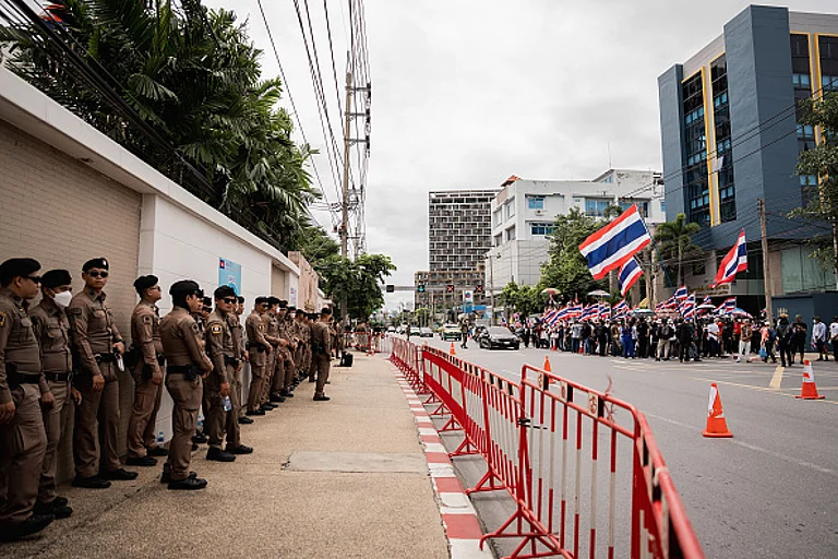 Thai police officers line up in front of the Cambodian Embassy in Bangkok as protesters gather across the street. - (Photo by Ploy Phutpheng/SOPA Images/LightRocket via Getty Images)