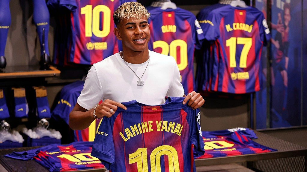 FC Barcelona player Lamine Yamal poses with his new jersey after signing a contract extension with the soccer club in Barcelona, northern Spain, Wednesday, July 16, 2025. -  (AP Photo/Joan Monfort)