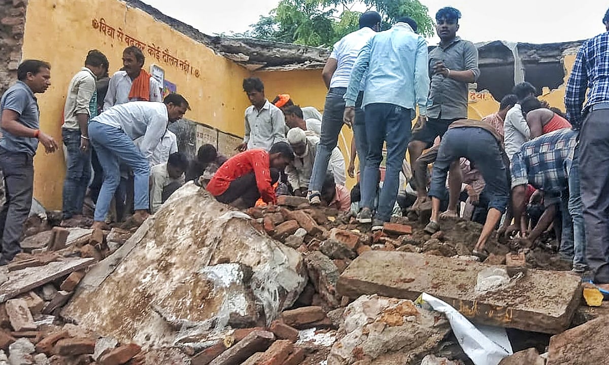 Locals during rescue work after a government school building collapsed in Jhalawar district, Rajasthan, Friday, July 25, 2025. At least four students were killed and 17 others suffered injuries in the incident.