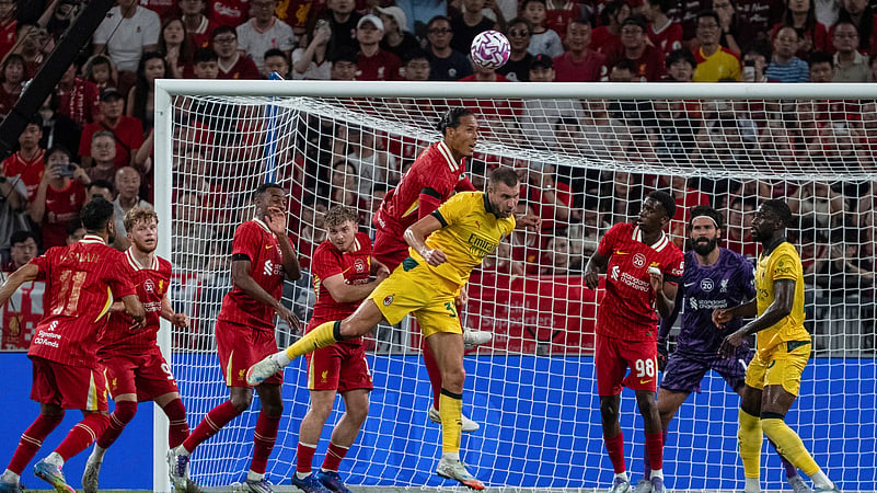 Liverpools Virgil van Dijk, centre left, fights for the ball with AC Milan. AP