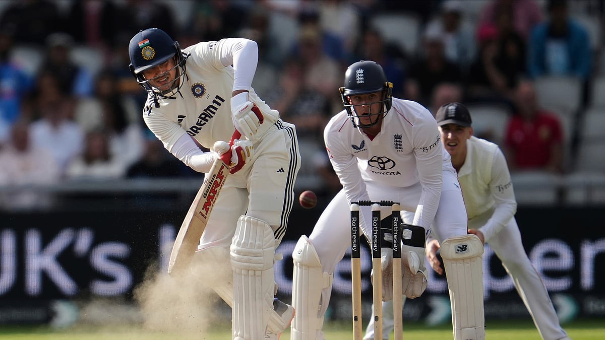 AP Photo/Jon Super : India's captain Shubman Gill plays a shot on the fourth day of the fourth cricket test match between England and India at Emirates Old Trafford, Manchester.