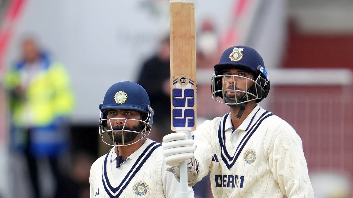 AP Photo/Jon Super : India's Washington Sundar, right, celebrates after scoring fifty runs on the final day of the fourth cricket test match between England and India at Emirates Old Trafford, Manchester.