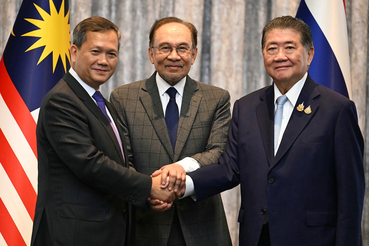 Malaysia's Prime Minister Anwar Ibrahim, center, Cambodia's Prime Minister Hun Manet left and Thailand's acting Prime Minister Phumtham Wechayachai pose for photos after talks on a possible ceasefire between Thailand and Cambodia in Putrajaya, Malaysia, Monday, July 28, 2025. - Mohd Rasfan via AP