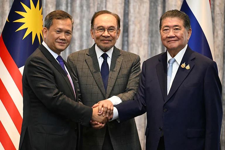 Malaysia's Prime Minister Anwar Ibrahim, center, Cambodia's Prime Minister Hun Manet left and Thailand's acting Prime Minister Phumtham Wechayachai pose for photos after talks on a possible ceasefire between Thailand and Cambodia in Putrajaya, Malaysia, Monday, July 28, 2025. - Mohd Rasfan via AP