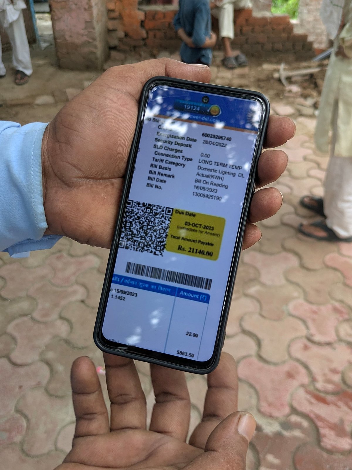 One resident shows his electricity bill from 2013 