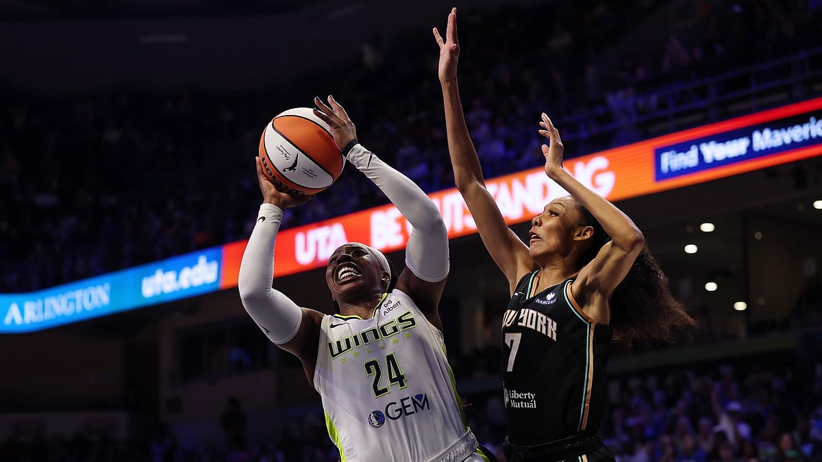 Arike Ogunbowale of the Dallas Wings drives on Rebekah Gardner of the New York Liberty on July 28, 2025.
