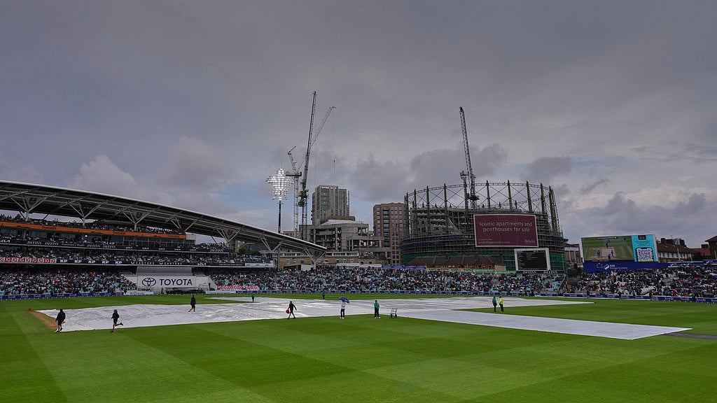 AP : India Vs England, 5th Test: Groundsmen cover the pitch to protect from rain on Day 1 at The Oval.