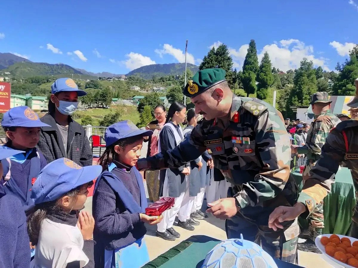 A soldier is giving  gifts to the children