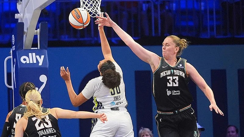 Photo: AP : New York Liberty centre Emma Meesseman (33) blocks a shot against Dallas Wings guard Haley Jones (30) during a WNBA basketball game in Arlington, Texas.