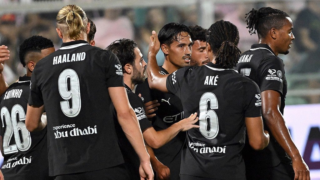 Photo: Giovanni Isolino/LaPresse via AP : Teammates congratulate Manchester City's Tijani Reijnders for his goal against Palermo during a pre-season friendly at the Renzo Barbera stadium in Palermo, Italy.