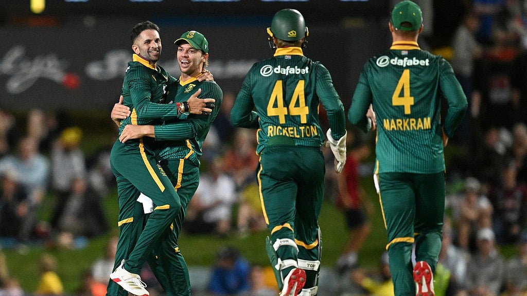 AP/DARREN ENGLAND : Keshav Maharaj, left, of South Africa is congratulated by teammates after getting the wicket of Cameron Green