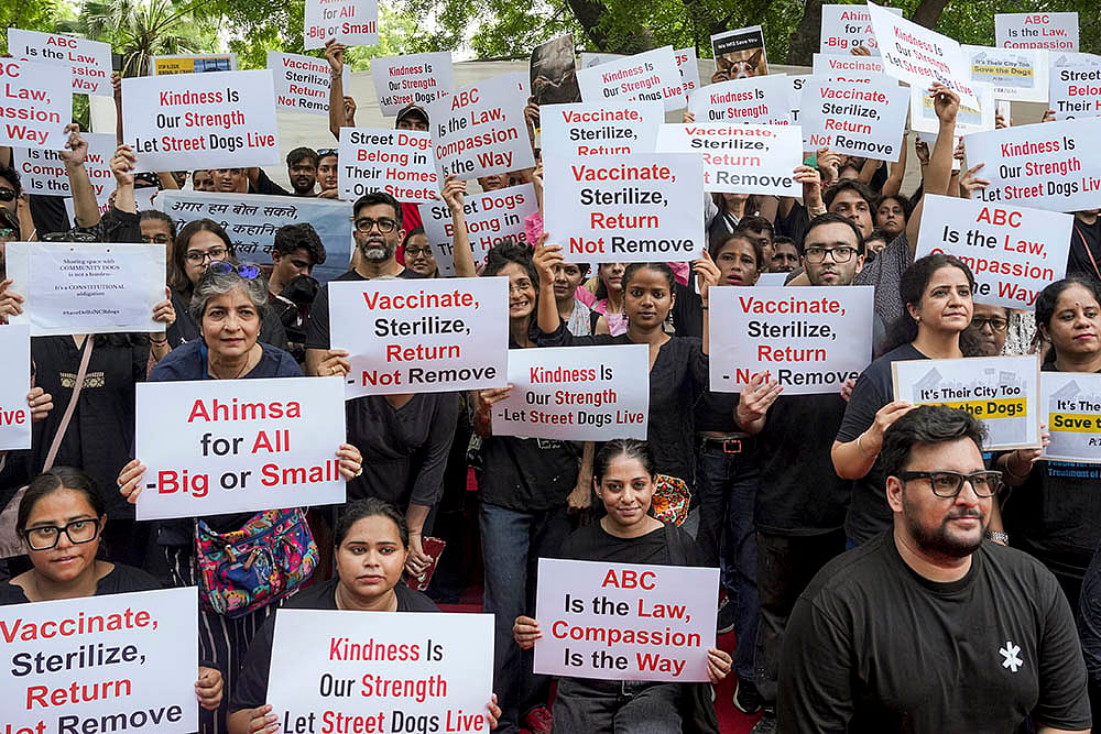 | Photo: PTI/Karma Bhutia : Protest against SC order on stray dogs issue