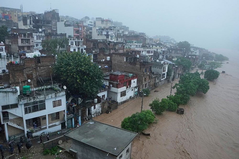 | Photo: AP/Channi Anand : Tawi river in spate in Jammu