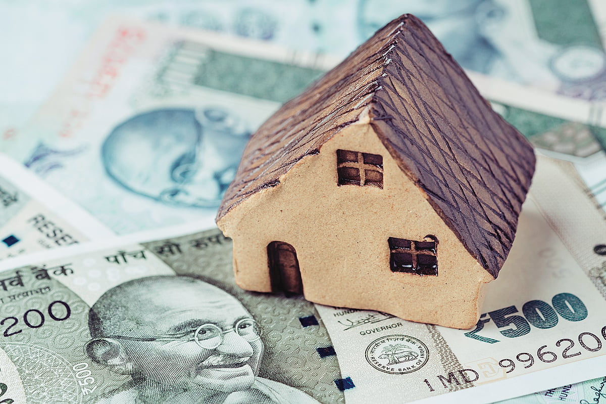 House model placed on Indian currency, symbolizing housing demand in India