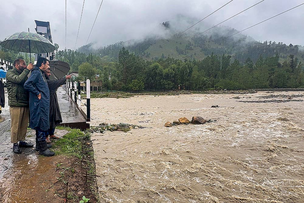 | Photo: PTI : Parts of Kashmir, including the southern part of the Valley, particularly Anantang district, faced the brunt of heavy rains submerging several areas.
