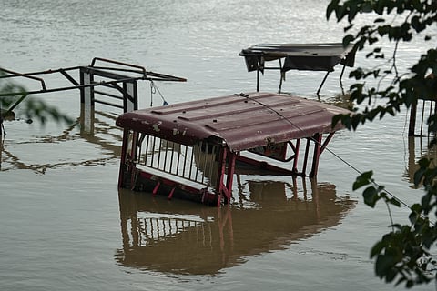An electric rickshaw submerged in the flood waters. 
