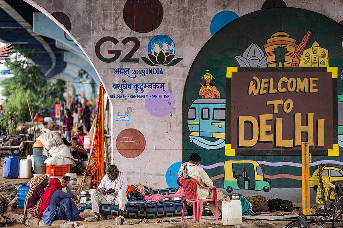 Flood-hit people take shelter under flyovers in Delhi