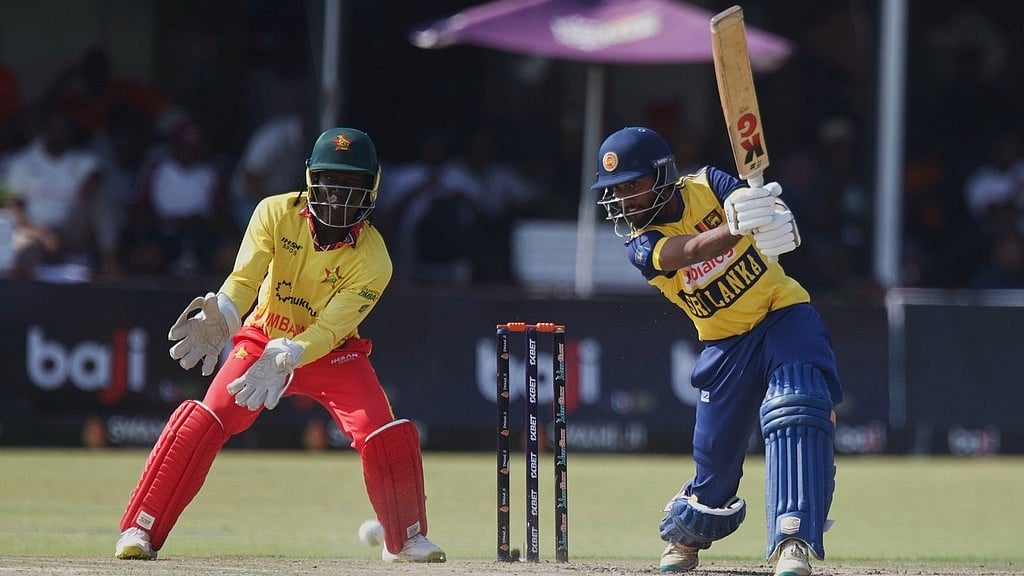 AP : Sri Lanka's batsman Dushan Hemantha, right, plays a shot as Zimbabwe's wicketkeeper Tadiwanashe Marumani watches on during the T20 International cricket match between Zimbabwe and Sri Lanka, at the Harare Sports Club, in Harare, Zimbabwe, Saturday, Sept. 6, 2025.