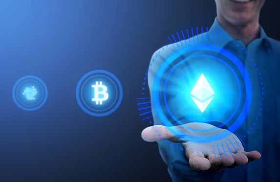 A hand holding a glowing blue tech device
