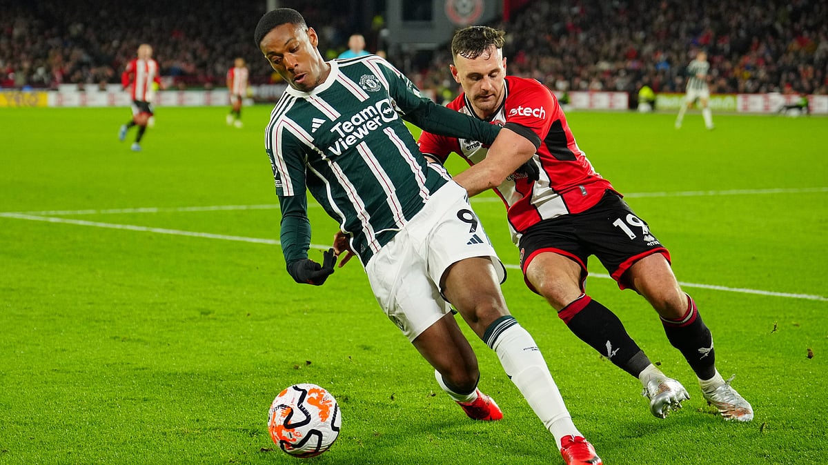 | Photo: AP/Jon Super : File photo of Manchester United's Anthony Martial, left, challenging for the ball with Sheffield United's Jack Robinson during the English Premier League soccer match between Sheffield United and Manchester United at Bramall Lane in Sheffield, England, Oct. 21, 2023.