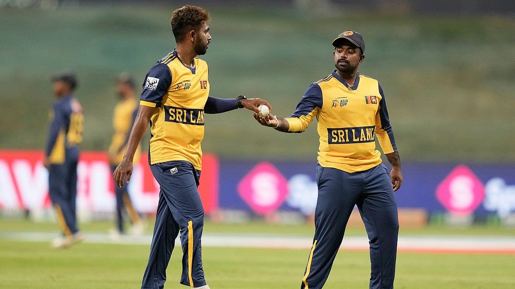 AP : Sri Lanka's captain Charith Asalanka, right, hands the ball to teammate Nuwan Thushara during the Asia Cup match against Bangladesh in Abu Dhabi.
