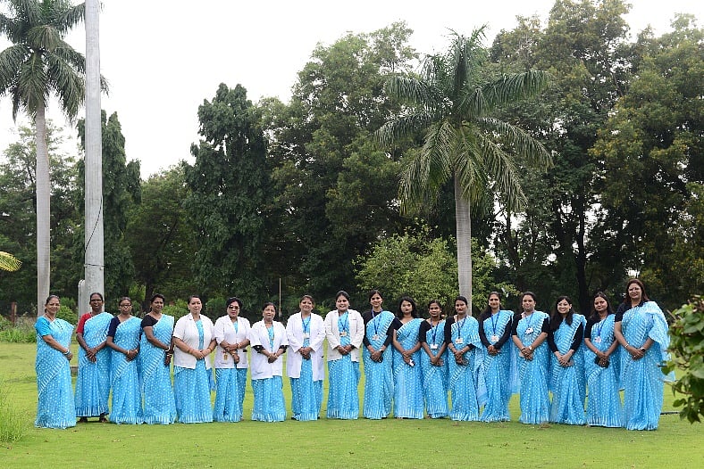 HCL women employees wearing their new uniform and standing for a photo