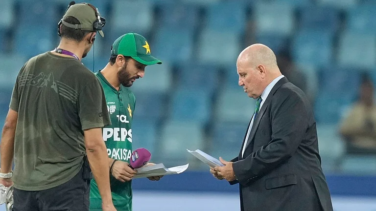 Pakistan's captain Salman Agha shares team list with match referee Andy Pycroft at the toss before the Asia Cup 2025 match against UAE. - AP