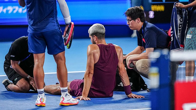 Carlos Alcaraz receives treatment on his left foot. - null