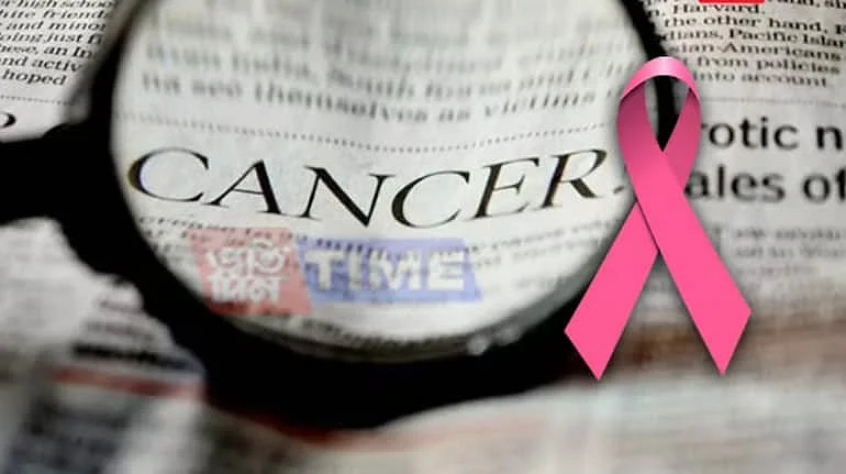 A magnifying glass focused on the word Cancer on a newspaper