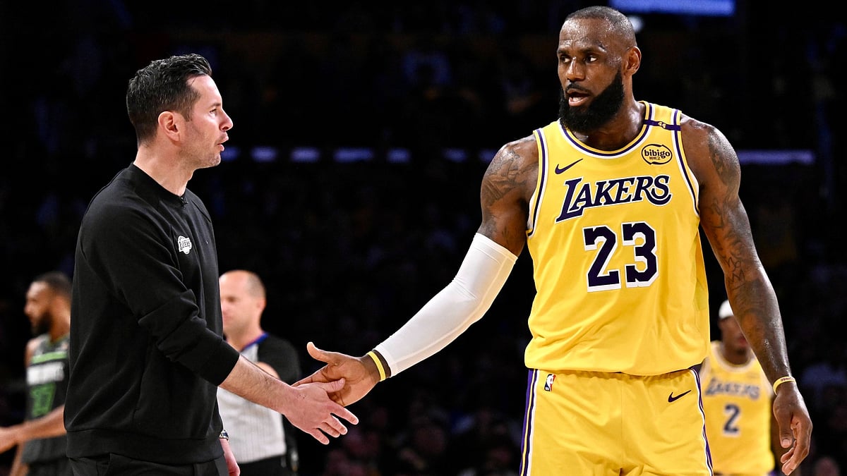 Los Angeles Lakers coach JJ Redick shakes hands with superstar LeBron James.
