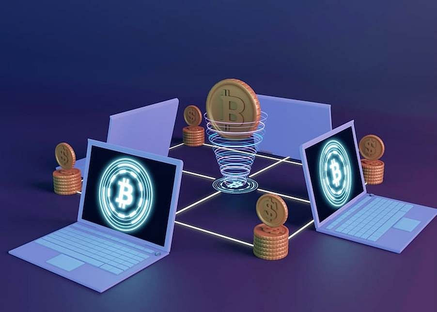 Conceptual image of a decentralized network with two laptops and Bitcoin coins