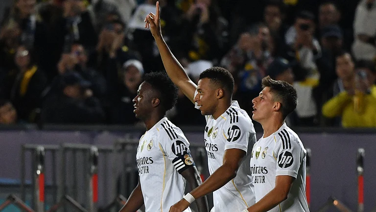 Kylian Mbappe celebrates the second of his three goals - null