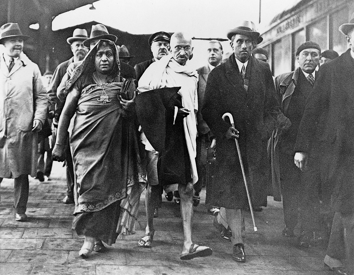 MOHANDAS GANDHI (1869-1948). With poet Sarojini Naidu en-route to the Second Round Table Conference in London, England. Photograph, 1931 - CreditIMAGO / GRANGER Historical Picture Archive

