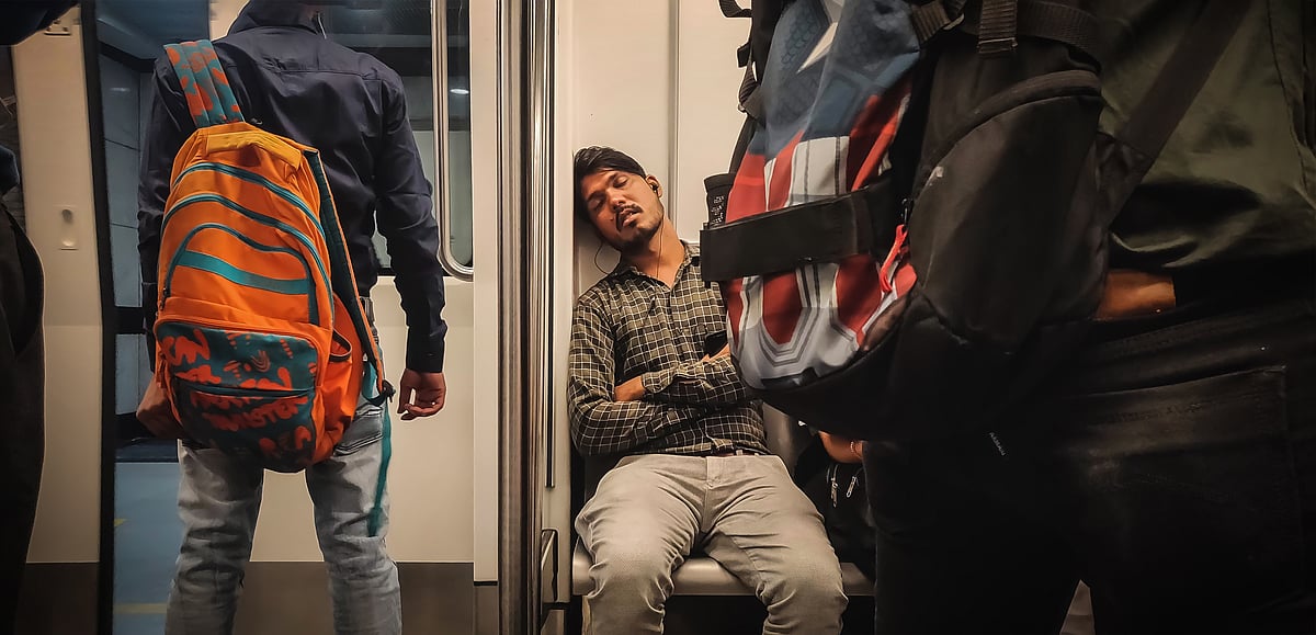 Shutterstock : Man sleeping in a metro