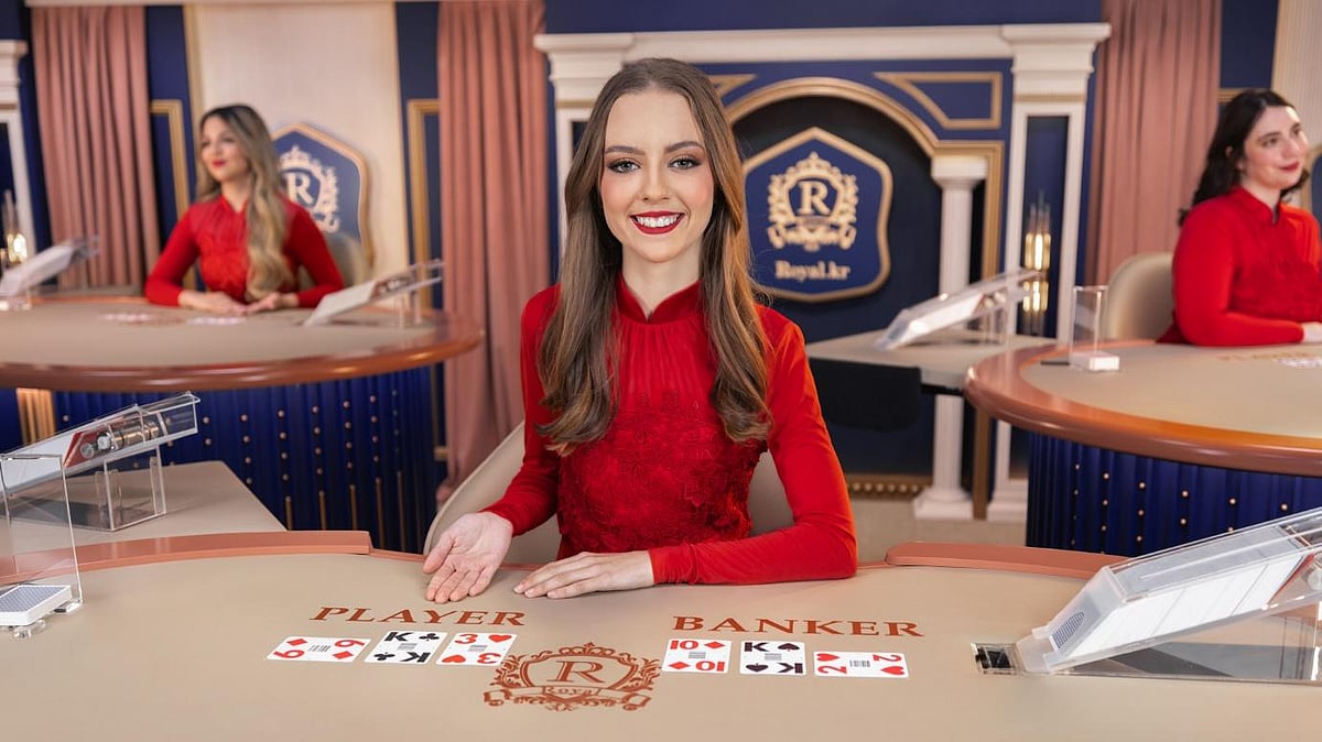 Woman in red dress at baccarat table in casino