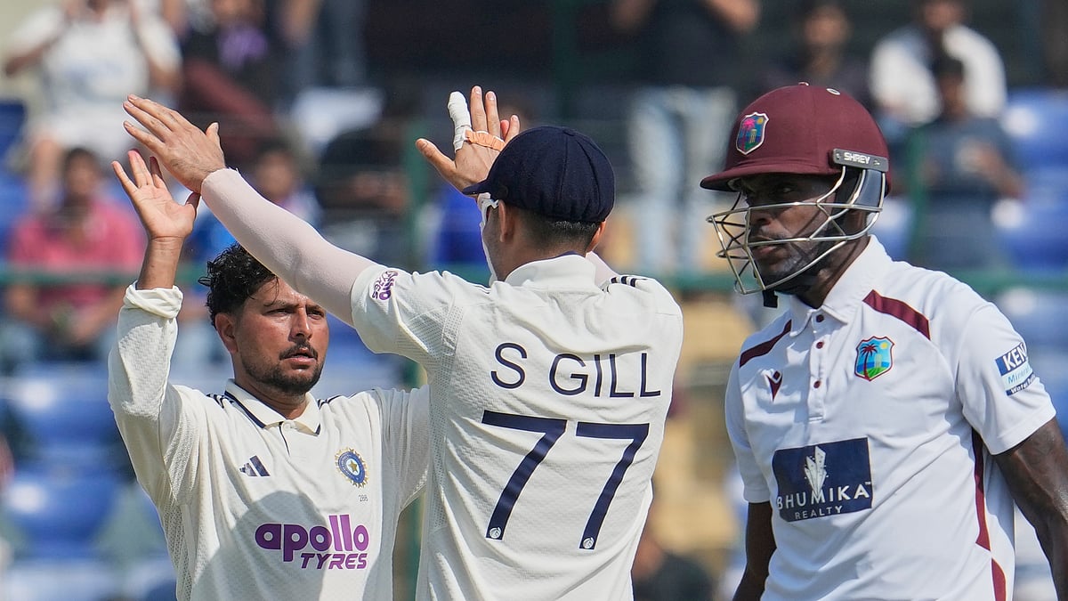 (AP Photo/Manish Swarup) : India's Kuldeep Yadav, left, celebrates the dismissal of West Indies' Justin Greaves with captain Shubman Gill on the third day of the second cricket test match between India and West Indies at the Arun Jaitley Stadium in New Delhi, India, Sunday, Oct.12, 2025.