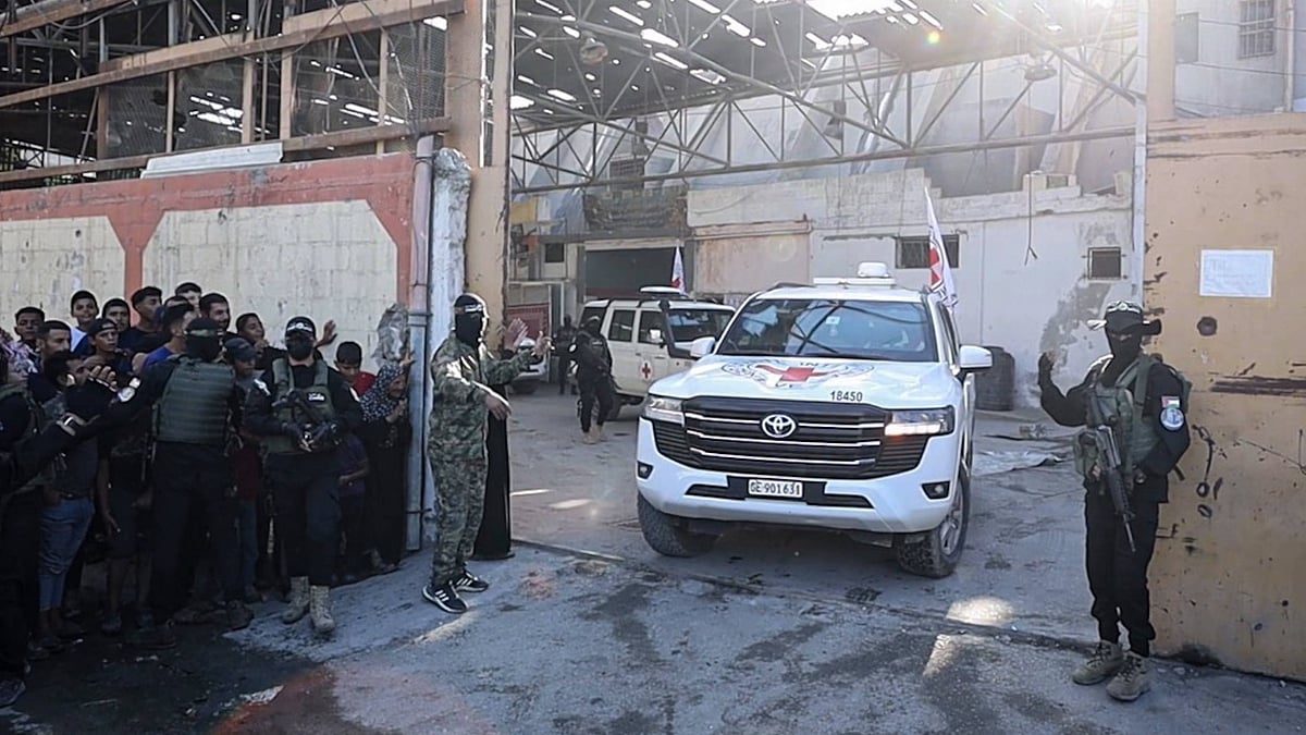 | IMAGO / Anadolu Agency : Hamas members hand over some of the 20 Israeli hostages to International Committee of the Red Cross (ICRC) teams as part of the ceasefire and hostage-prisoner exchange agreement between Hamas and Israel on October 13, 2025 in Gaza City, Gaza. (representational image)
