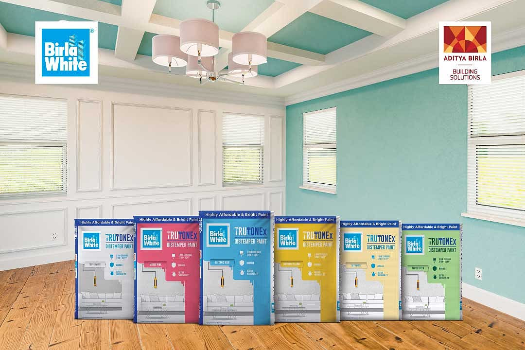 Birla White TRUTONEx  Distemper Paint cans in an interior room setting.