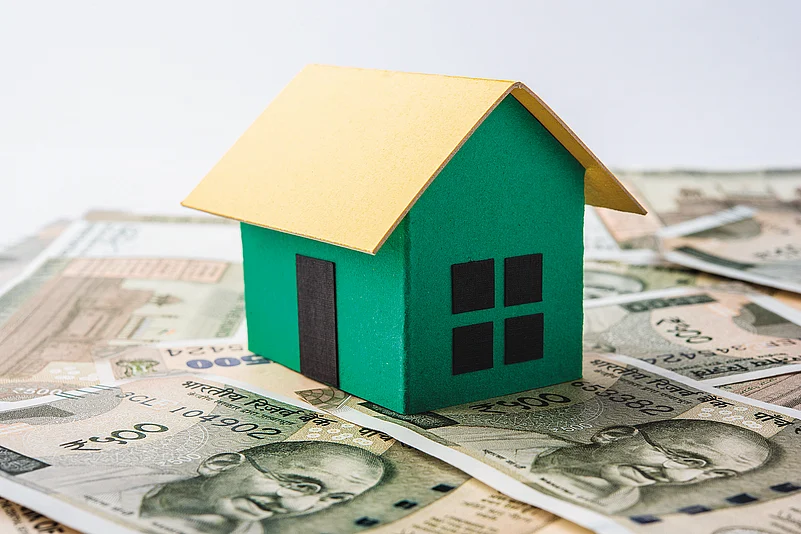 A house model placed on Indian currency notes