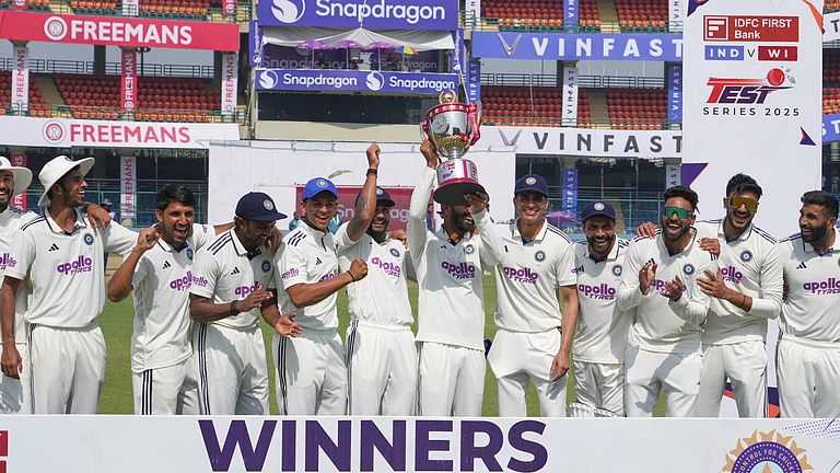 Indian players celebrate with the trophy after wining the India and West Indies test match series at the Arun Jaitley Stadium in New Delhi, India, Tuesday, Oct.14, 2025. - (AP Photo/Manish Swarup)