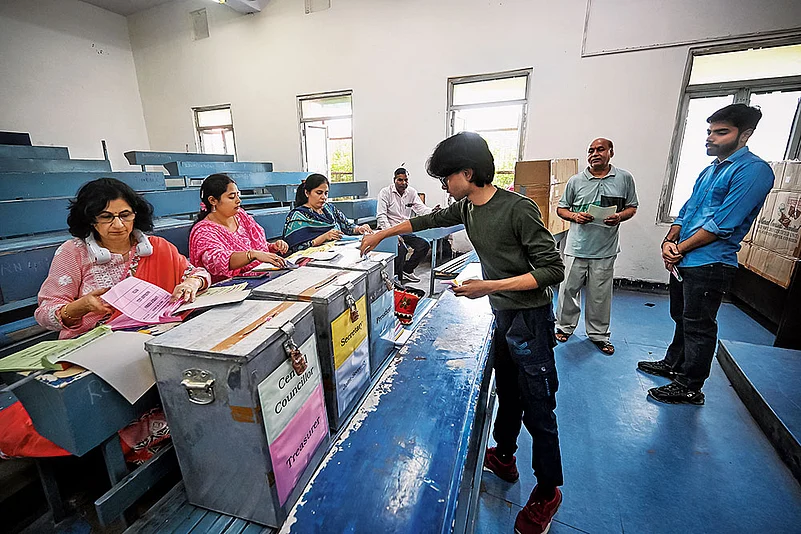 A student casting his vote at Ramjas College, New Delhi