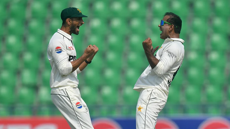Pakistans Noman Ali celebrates with Shan Masood