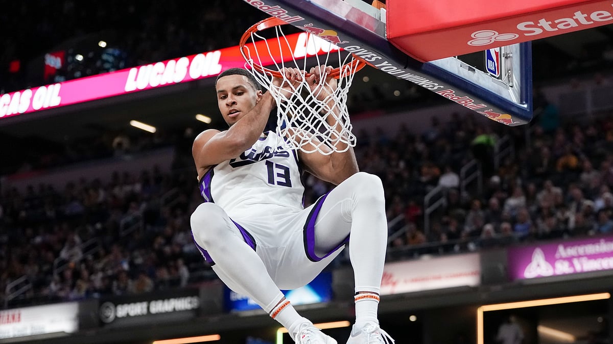 Keegan Murray #13 of the Sacramento Kings hangs on the rim after dunking the ball in the first quarter against the Indiana Pacers at Gainbridge Fieldhouse on March 31, 2025 in Indianapolis, Indiana.