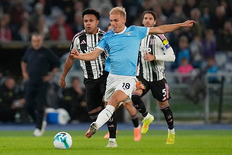 Juventus' Weston McKennie, left, and Lazio's Gustav Isaksen fight for the ball during the Italian Serie A soccer match between Lazio and Juventus in Rome.