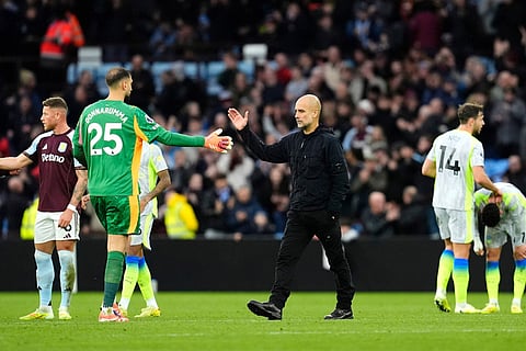 Manchester City manager Pep Guardiola (centre) shake hands with goalkeeper Gianluigi Donnarumma following defeat in the English Premier League match between Aston Villa and Manchester City, in Birmingham, England. 