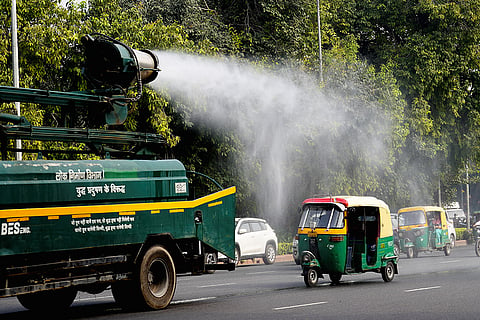 An anti-smog gun sprays water droplets to curb air pollution, in New Delhi.