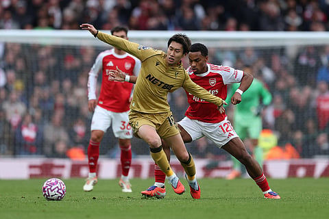 Crystal Palace's Daichi Kamada, left, challenges for the ball with Arsenal's Jurrien Timber during the English Premier League soccer match between Arsenal and Crystal Palace in London.