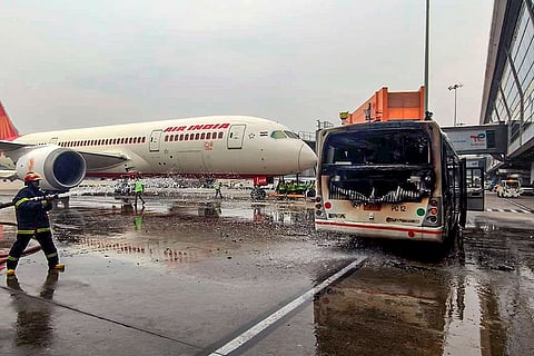 In this image posted on Oct. 28, 2025, Charred remains of an Air India SATS bus which caught fire near a parked aircraft at Delhi Airport’s Terminal 3.