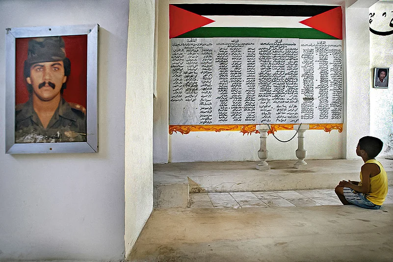 Homage to the Martyrs: A child sitting at the memorial for thousands of Palestinians
