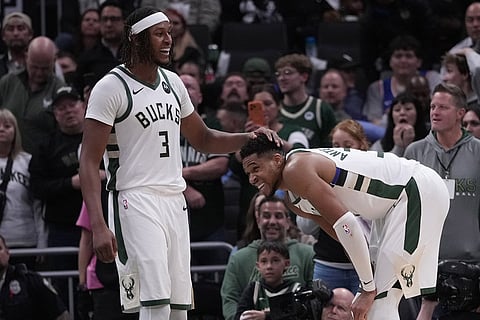 Milwaukee Bucks' Kyle Kuzma fouls New York Knicks' Karl-Anthony Towns during the first half of an NBA basketball game in Milwaukee. 
